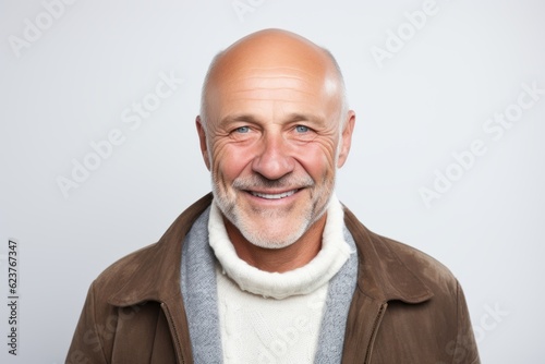 Portrait of a happy senior man smiling at camera over white background