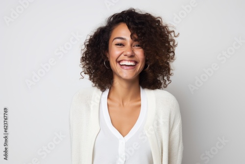 Portrait of a happy young african american woman laughing over white background
