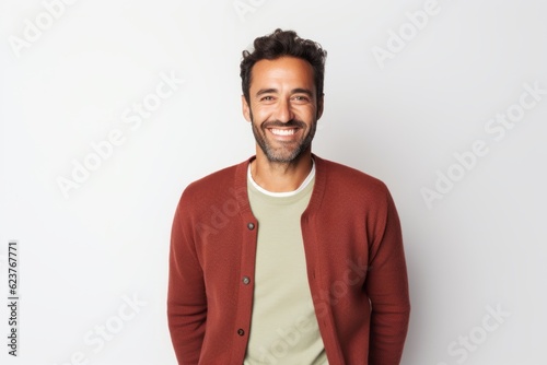 Portrait of happy latin man smiling at camera over white background