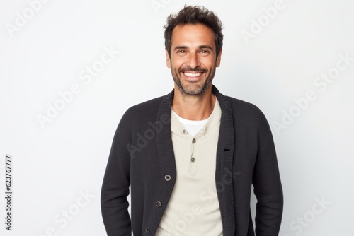 Portrait of a handsome man smiling at the camera over white background