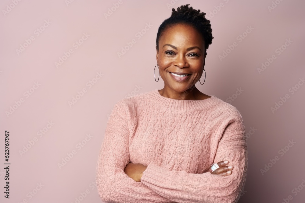 Portrait of a smiling african american woman in a pink sweater