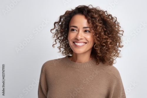 Portrait of a beautiful young woman with curly hair on a white background