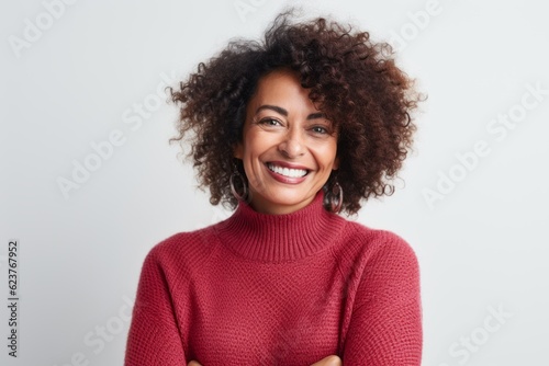 Portrait of a smiling african american woman with curly hair isolated on a white background © Robert MEYNER