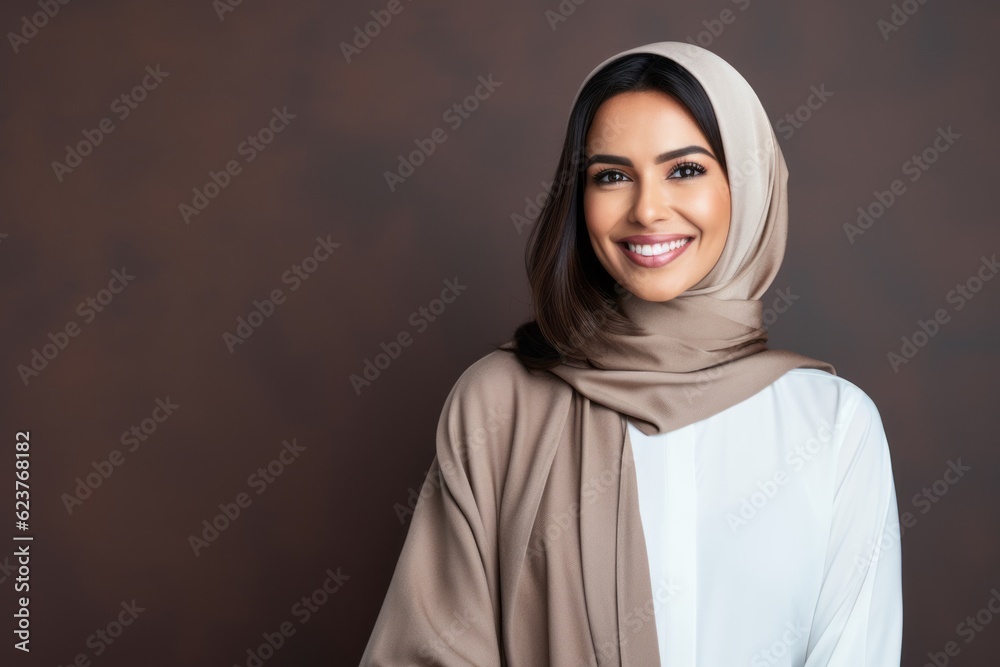 Portrait of a beautiful muslim woman wearing hijab smiling at camera