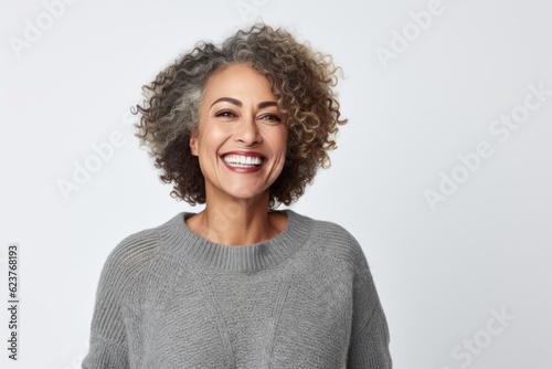 Portrait of a beautiful smiling woman with curly hair over white background