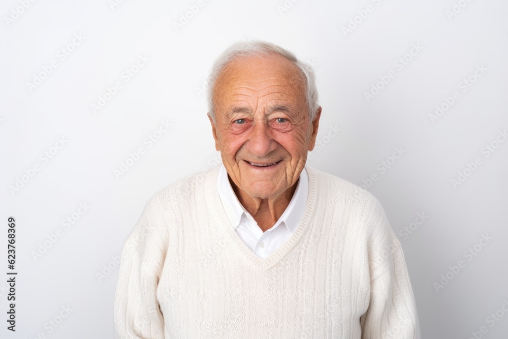 Portrait of happy senior man smiling and looking at camera against white background Portrait of happy senior man smiling and looking at camera against white background
