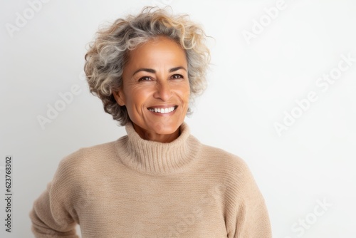 Portrait of a beautiful middle aged woman smiling at the camera on a white background