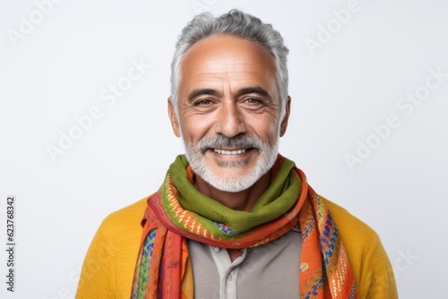 Portrait of a smiling Indian man wearing scarf and looking at camera