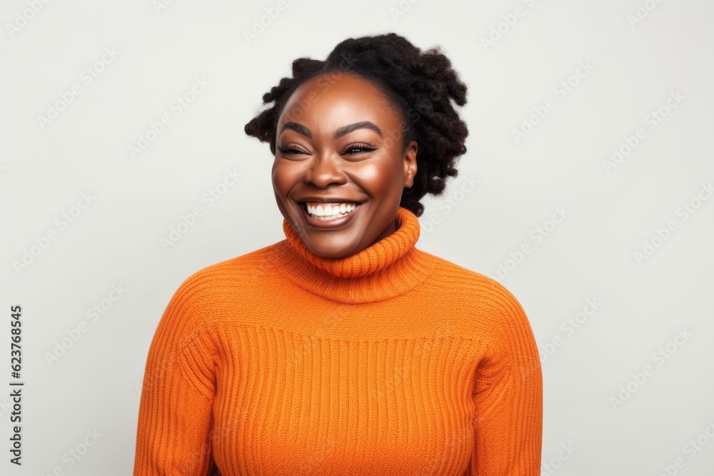 Happy african american woman in orange sweater on white background. Happy african american woman in orange sweater on white background.
