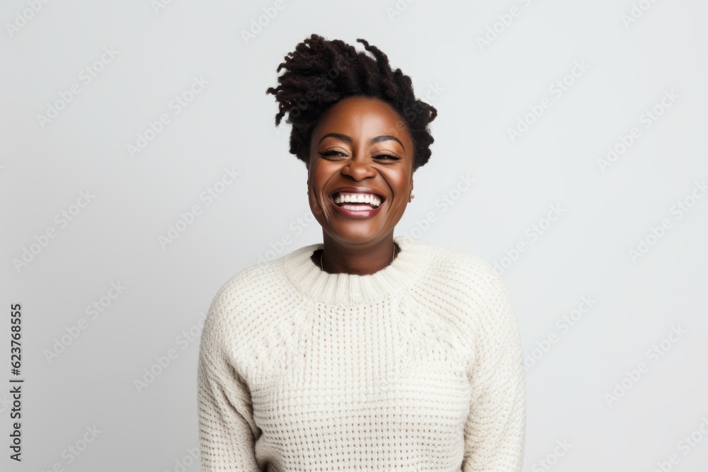 Obraz premium Portrait of a happy african american woman laughing against white background