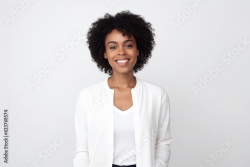 Portrait of smiling african american businesswoman standing over white background