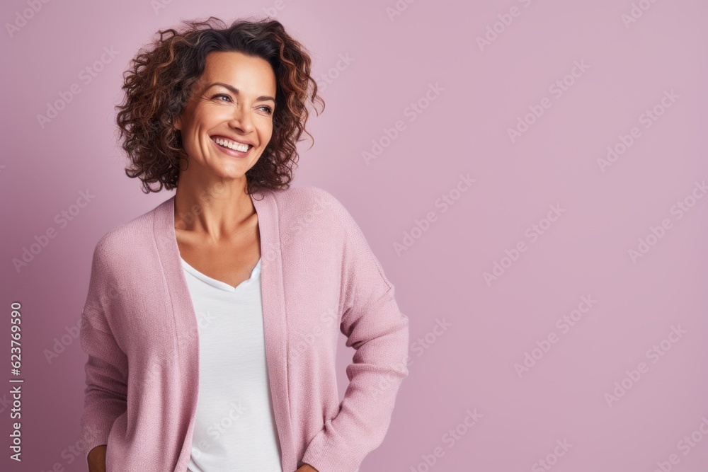 Smiling young woman with curly hair looking at the camera with a smile Smiling young woman with curly hair looking at the camera with a smile
