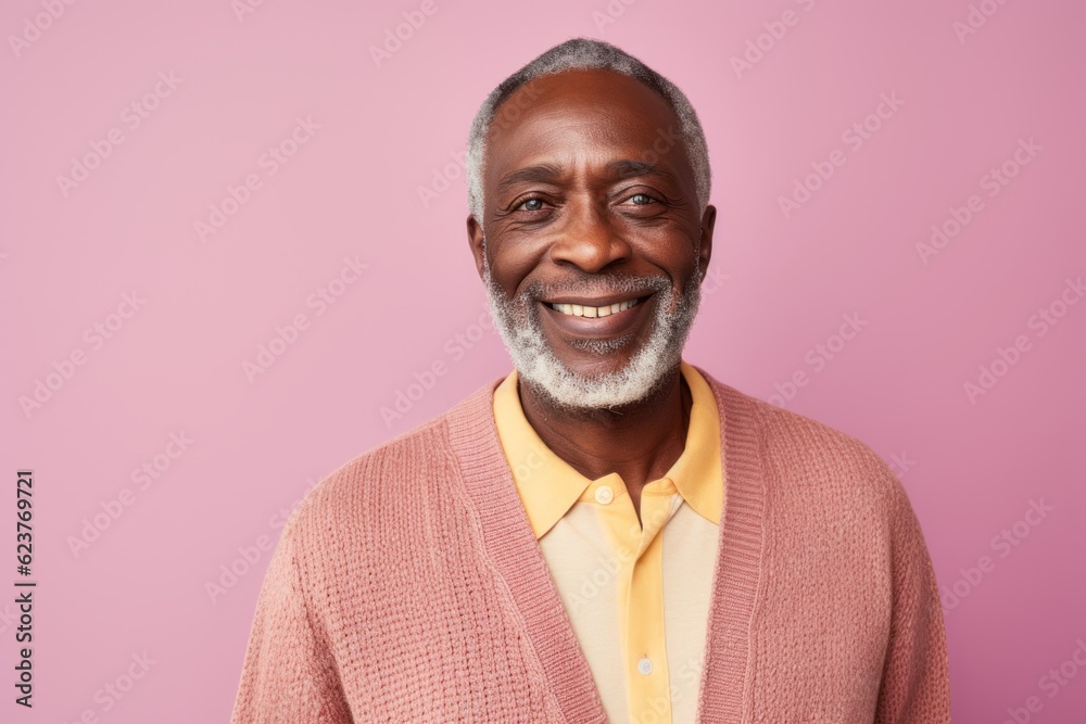 Portrait of happy african american senior man with white beard smiling at camera, standing against pink background Portrait of happy african american senior man with white beard smiling at camera, standing against pink background
