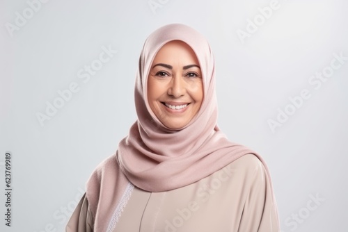 portrait of beautiful muslim woman wearing hijab smiling at the camera