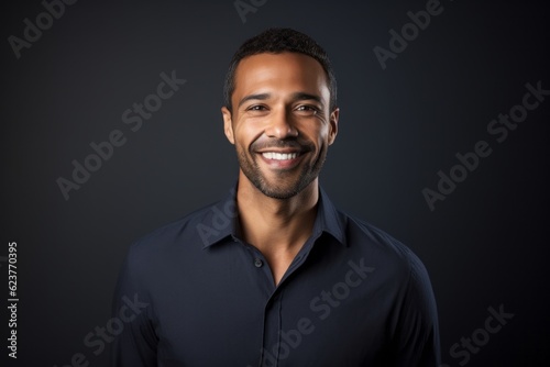 Portrait of a smiling african american man on black background