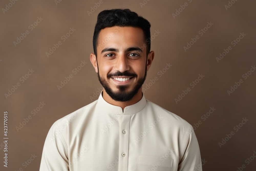 Portrait of handsome arabic man in white shirt on brown background