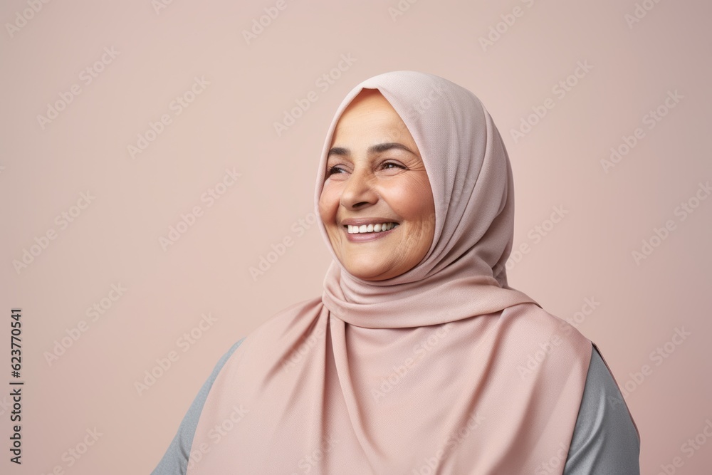 Portrait of muslim woman with hijab smiling at camera over pink background Portrait of muslim woman with hijab smiling at camera over pink background