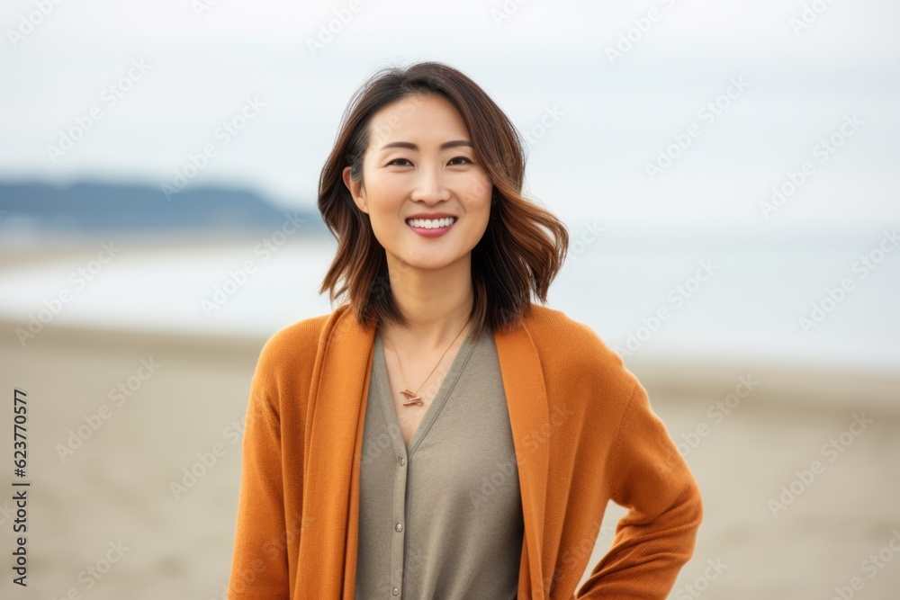 Portrait of a happy young asian woman standing on the beach Portrait of a happy young asian woman standing on the beach