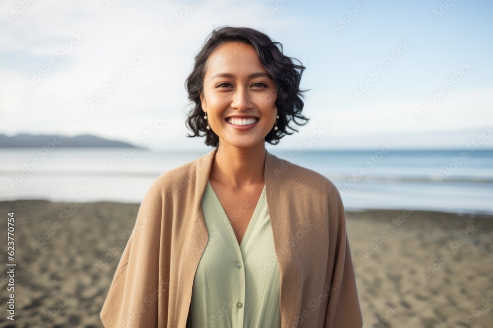 Portrait of smiling woman standing on the beach at the day time Portrait of smiling woman standing on the beach at the day time