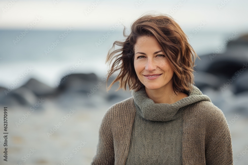 Portrait of a beautiful woman smiling on the beach at autumn day Portrait of a beautiful woman smiling on the beach at autumn day