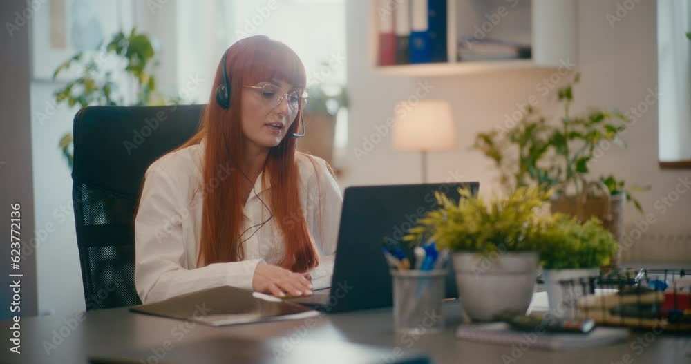 Customer representative working on laptop in office. Customer representative working on laptop in office.