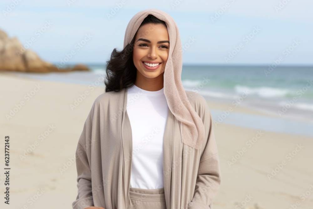 happy young woman in hooded coat on beach, summer vacation concept happy young woman in hooded coat on beach, summer vacation concept