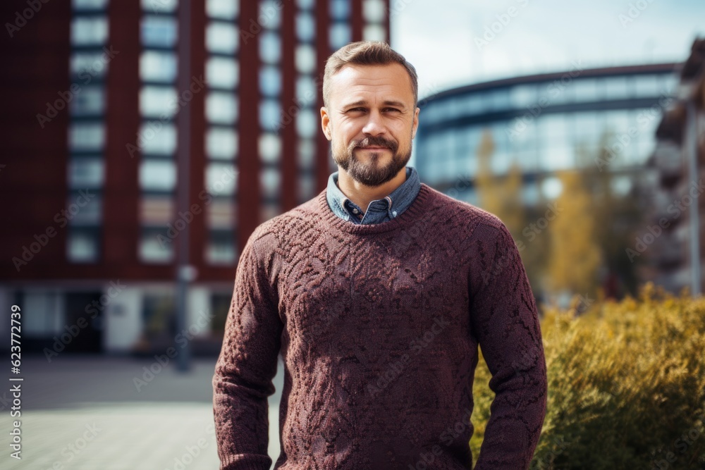 Portrait of a handsome man in a sweater on the street.