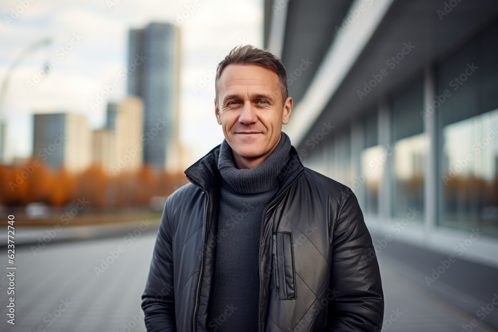 Portrait of a handsome man in a black leather jacket in the city Portrait of a handsome man in a black leather jacket in the city