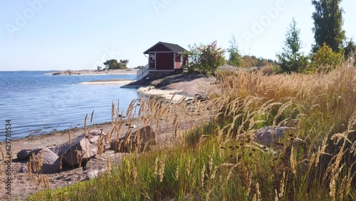 View of Hanko town coast, Hango, Finland, with beach and coastal waterfront, wooden houses and beach changing cabins, Uusimaa, Hanko Peninsula, Raseborg sub-region, summer sunny day  photo