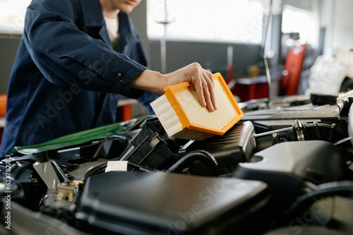 Schilderij op canvas Engine air filter replacement concept, closeup shot of auto mechanic at work