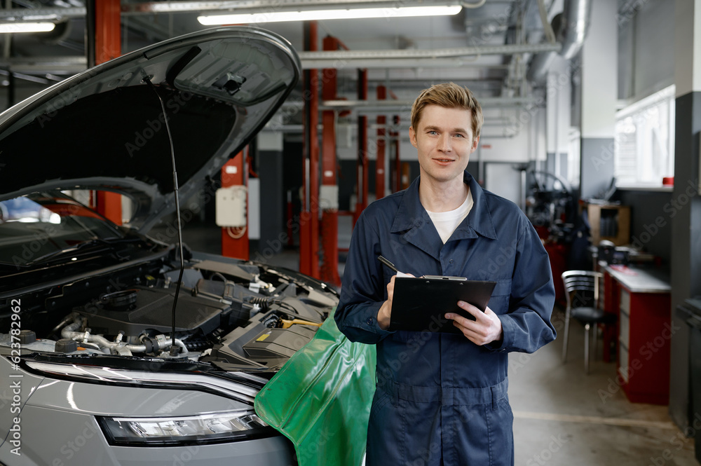 Portrait of smiling repairman mechanic at car service Portrait of smiling repairman mechanic at car service