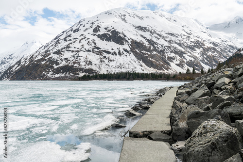 Ice sheets covering Portage Lake,  from the Begich Boggs Visitor Center with Bard Peak in the distance photo