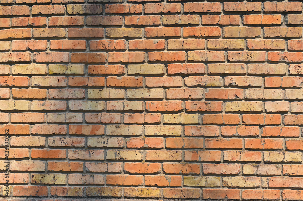 old red brick wall texture background. brightly lit red brick backdrop with copy space. outdoors