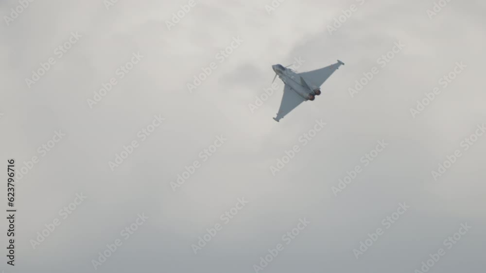 Fast fighter jet during high speed combat maneuvers with clouds Fast fighter jet during high speed combat maneuvers with clouds