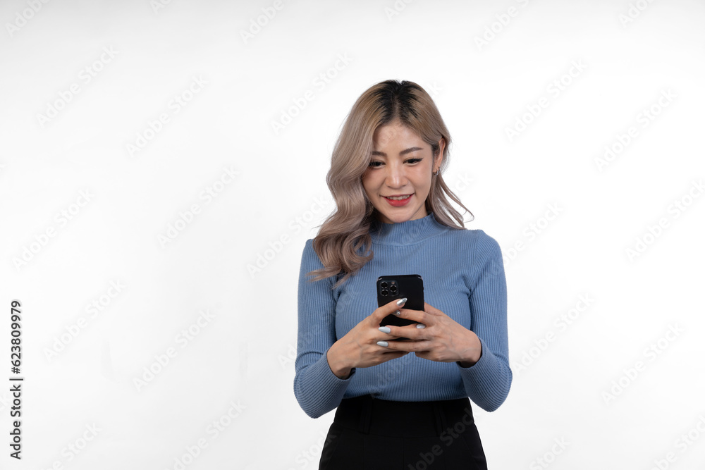 Portrait of confident Asian businesswoman Demonstrates motivation to work in business looking happy while using mobile phone to communicate online, isolated on white background. Portrait of confident Asian businesswoman Demonstrates motivation to work in business looking happy while using mobile phone to communicate online, isolated on white background.