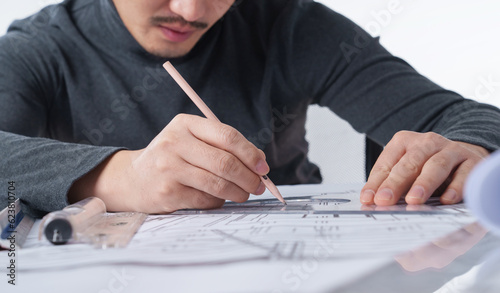 Close-up of an architectural designer who draws drawings photo