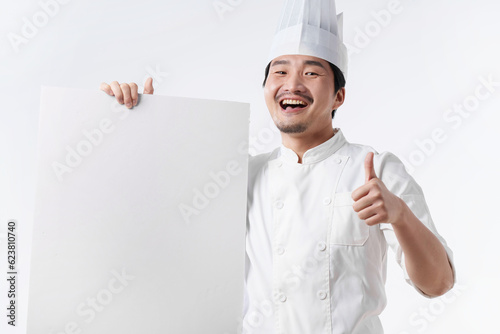 Middle-aged man in chef's uniform holding a whiteboard photo