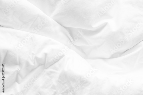 White bed sheet background, wrinkled duvet, crumpled satin blanket comforter cloth used in hotel, resort or home interior for bedding and sleep comfort