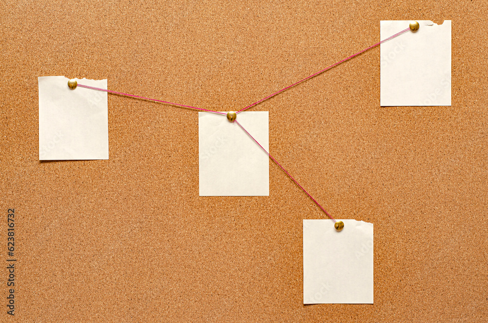 Blank paper notes are pinned to a cork board. The concept of detective investigation. Copy space. Blank paper notes are pinned to a cork board. The concept of detective investigation. Copy space.