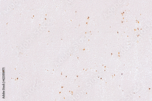 Metal surface with rust painted with light pink paint