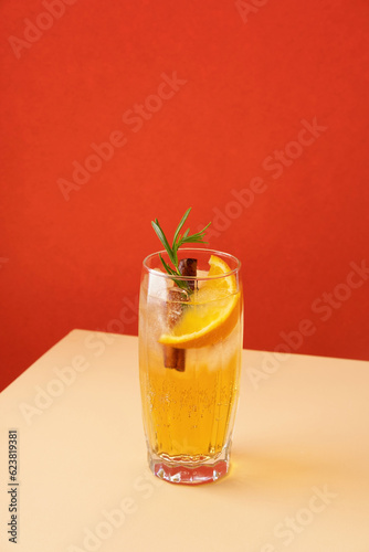 Fresh cocktail with orange, ice and herbs on the table. Refreshing drink on a hot summer day. Ice tea. Sangria or punch in a glass