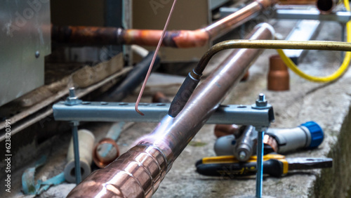 brazing copper pipes with a gas torch  photo
