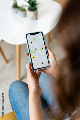 Woman holding mobile phone online gps application.