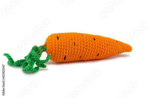 Artificial carrot with green leaves knitted from thick yarn