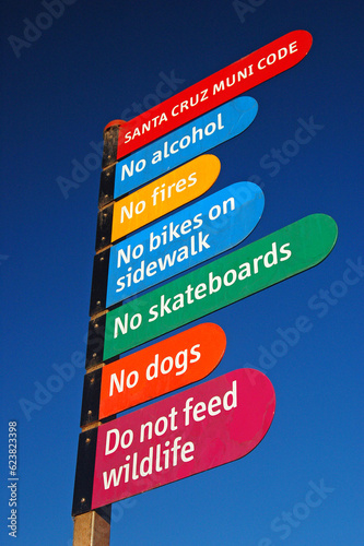 The Rules of Santa Cruz, California are posted on a colorful, public sign to inform people what is prohibited by law