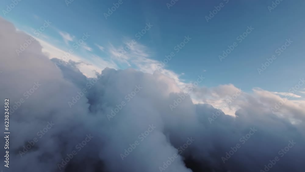 Flight between the clouds, first-person view of the aircraft during the flight at sunset. Planning between cloud clusters. aerial view Flight between the clouds, first-person view of the aircraft during the flight at sunset. Planning between cloud clusters. aerial view