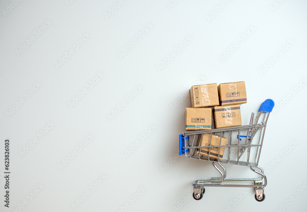 Shopping concept. Paper boxes in blue shopping cart on white background. online shopping consumers can shop from home and delivery service. with copy space