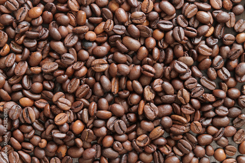 Top view of background representing halves of dark brown coffee beans. Roasted coffee beans, copy space