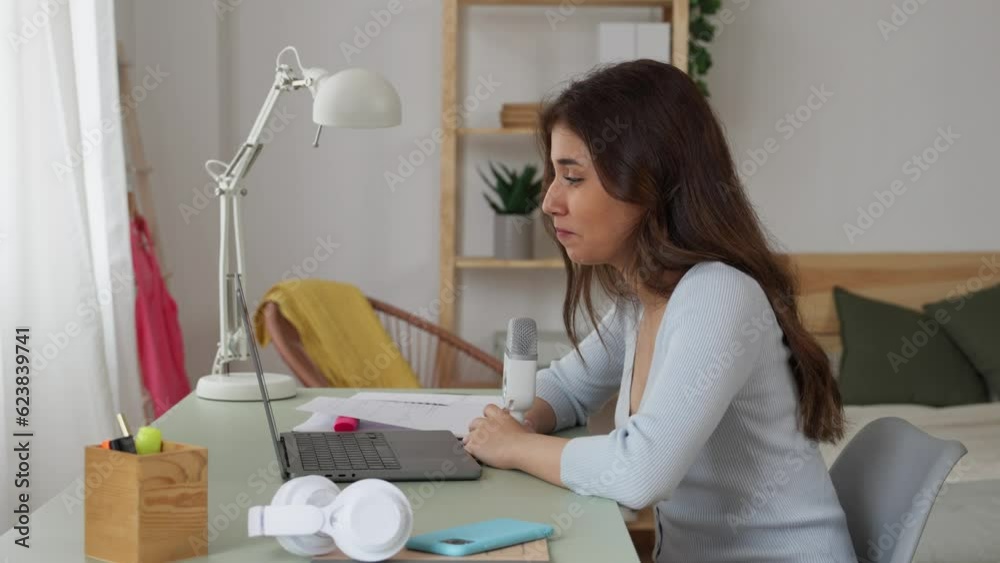 Woman recording a podcast with microphone and laptop. Woman recording a podcast with microphone and laptop.