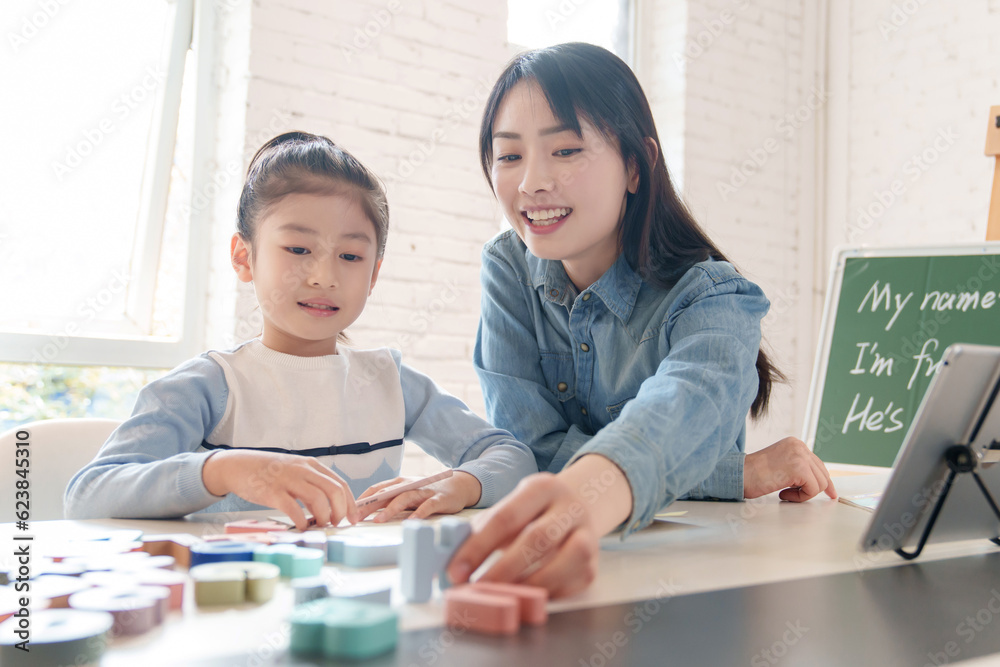 Tutors help elementary school students learn English Tutors help elementary school students learn English